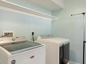 Laundry area featuring washing machine and clothes dryer