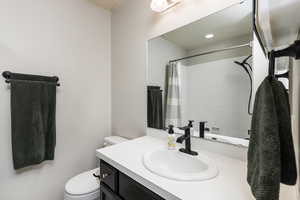 Full bathroom with vanity and a shower with curtain