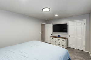 Bedroom featuring carpet floors and baseboards