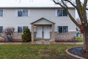 Traditional home with brick siding and a front lawn
