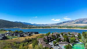 Aerial view of residential area featuring a water and mountain view