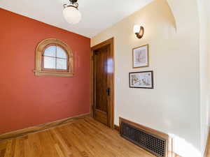 Foyer entrance with light wood-type flooring and baseboards