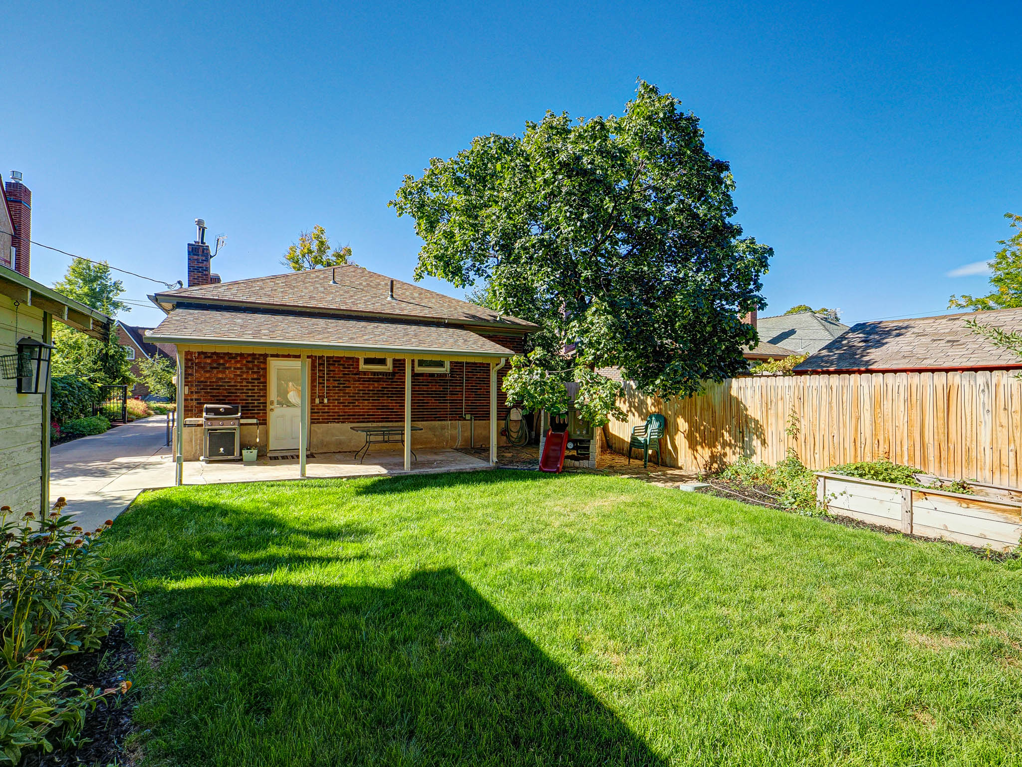 Fenced backyard with a patio area