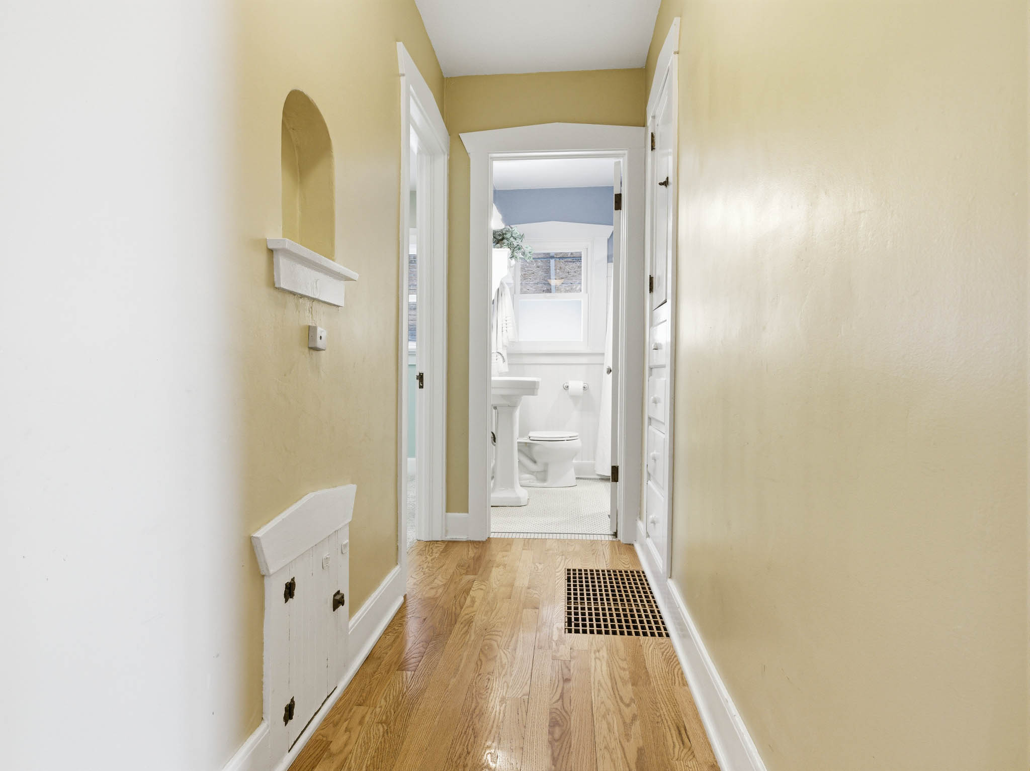Hall with wood-type flooring and baseboards