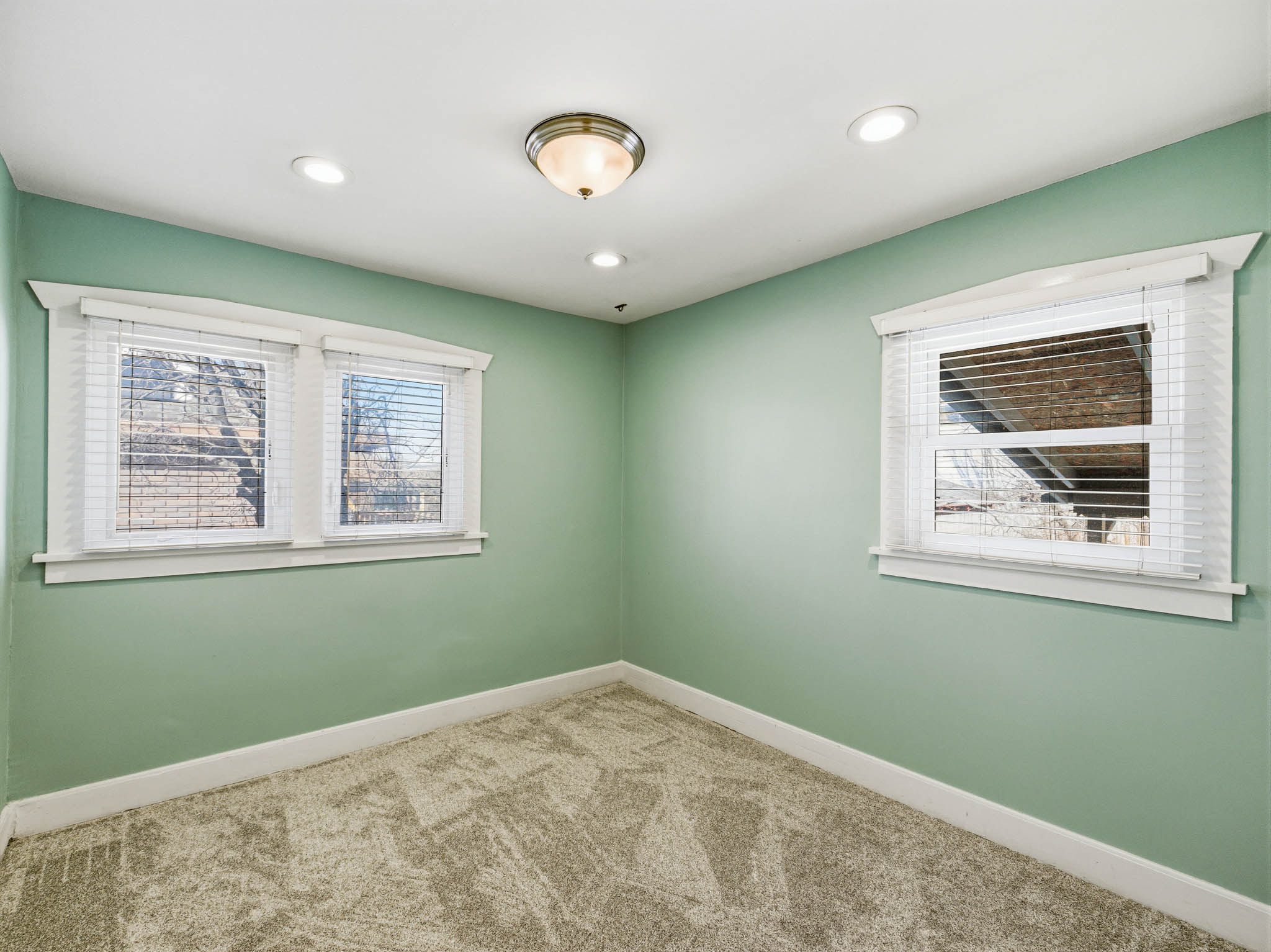 Empty room featuring carpet floors and recessed lighting