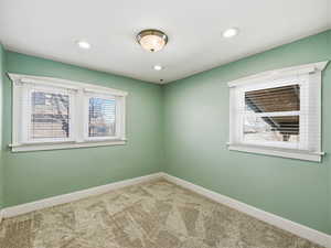 Empty room featuring carpet floors and recessed lighting