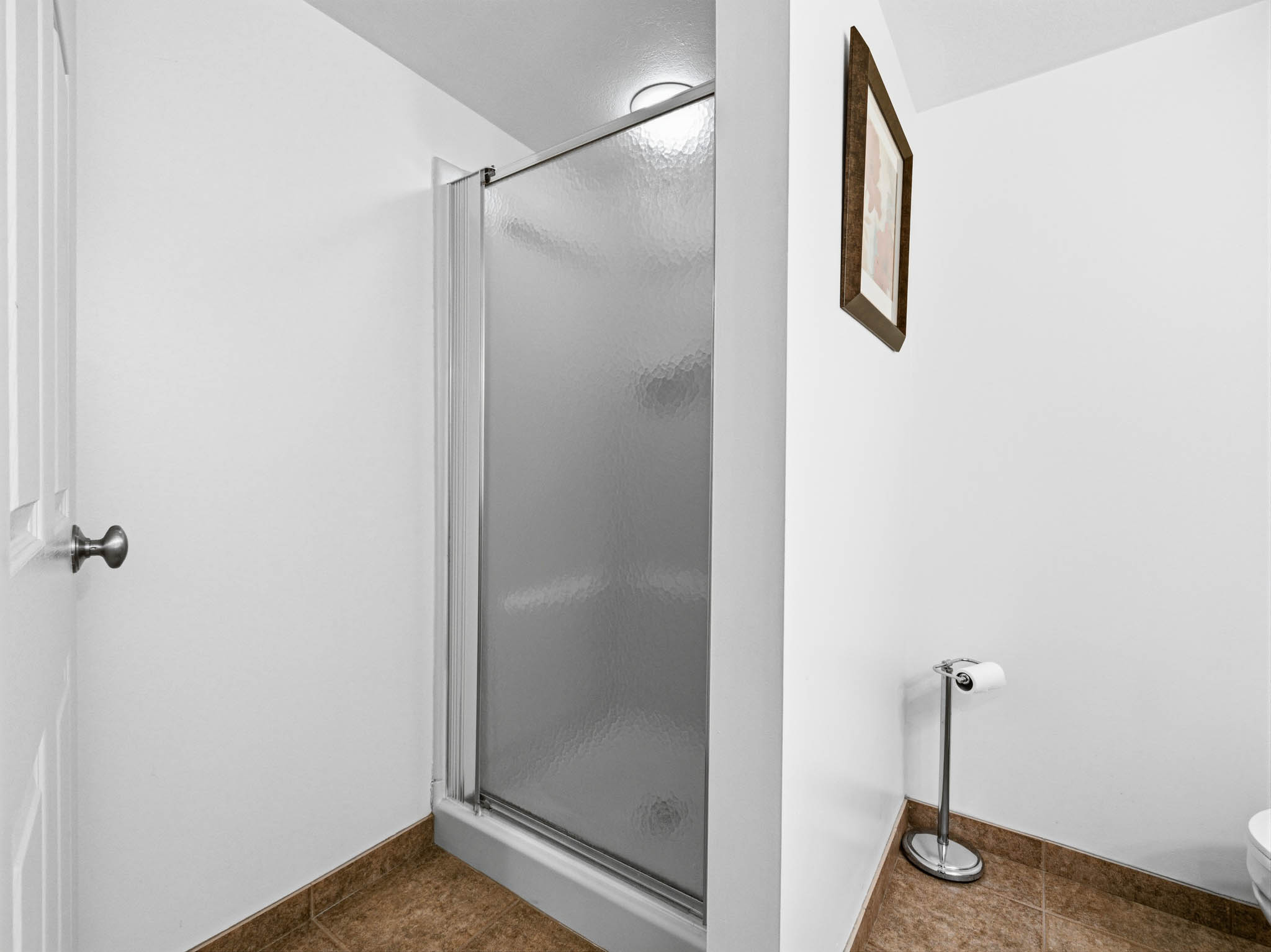 Bathroom featuring a stall shower and dark tile patterned floors
