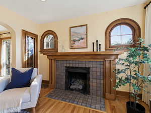 Living room featuring wood finished floors, plenty of natural light, and a fireplace
