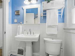 Bathroom with toilet and wainscoting