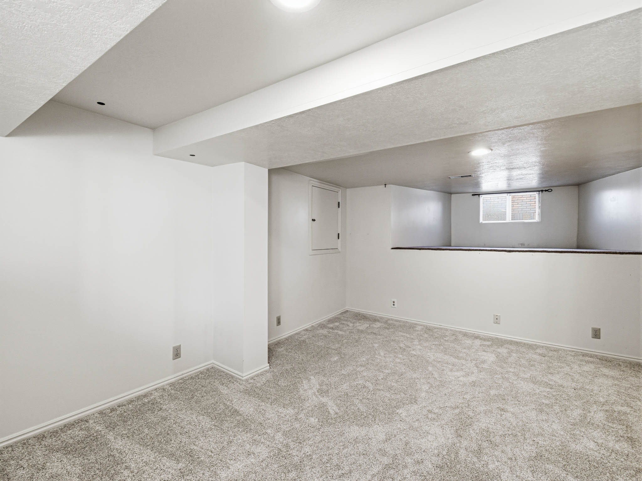Basement featuring light colored carpet and recessed lighting