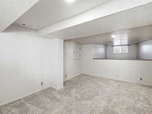 Basement featuring light colored carpet and recessed lighting