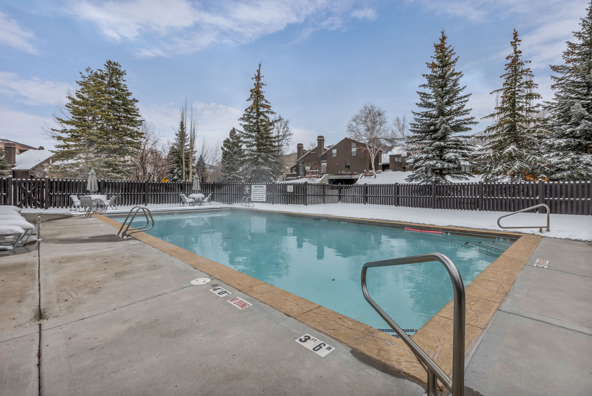 Community pool with a patio