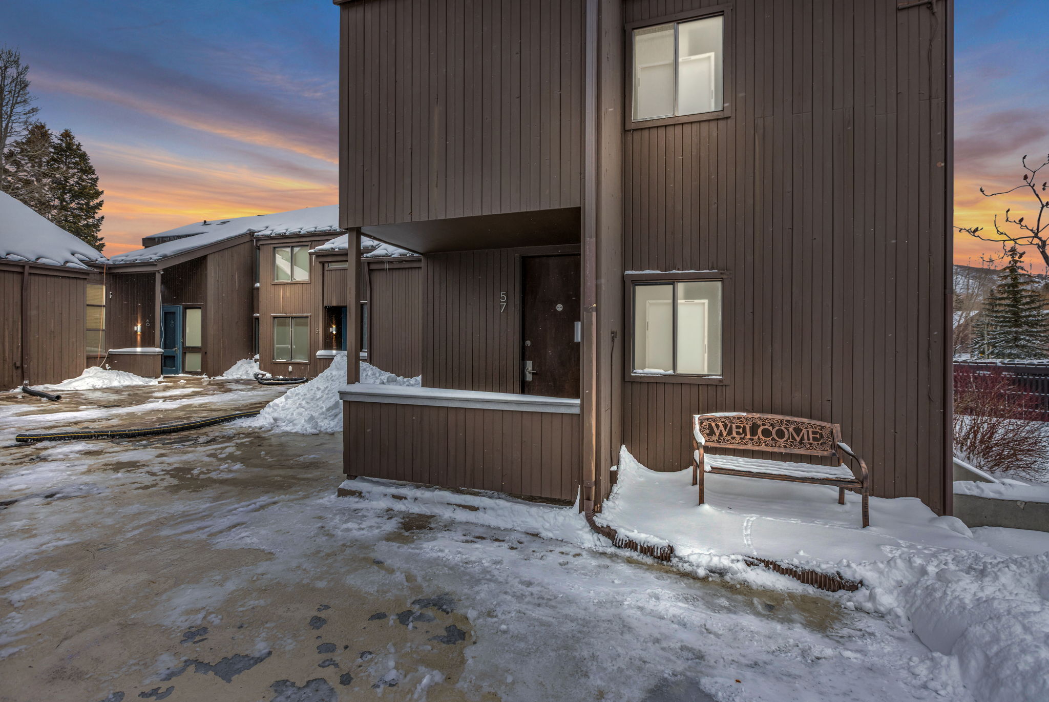 View of snow covered back of property
