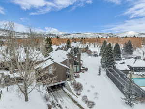 Snowy aerial view featuring a mountain view