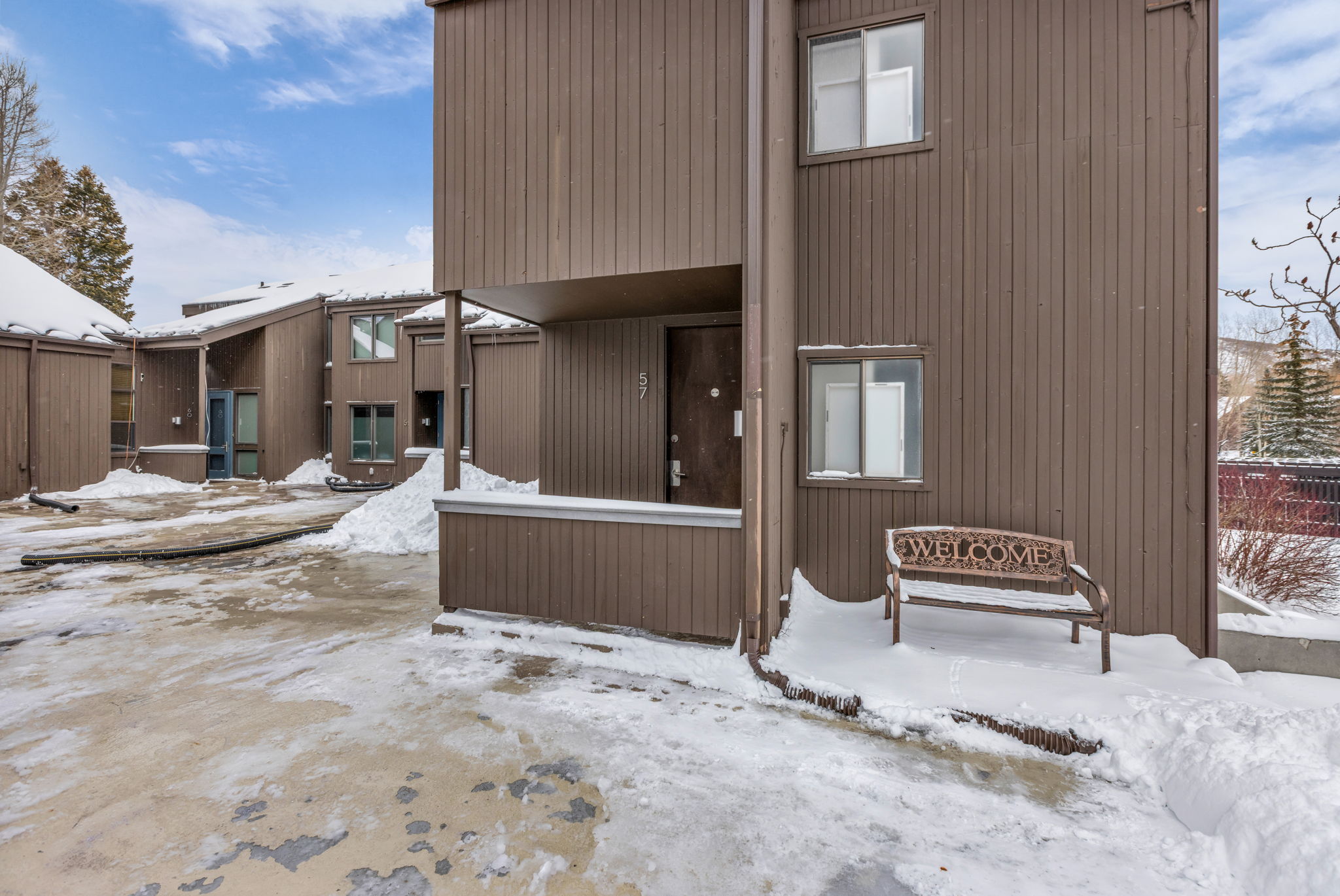 View of snow covered rear of property