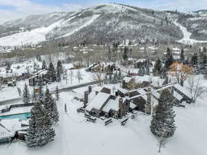 Snowy aerial view featuring a mountain view
