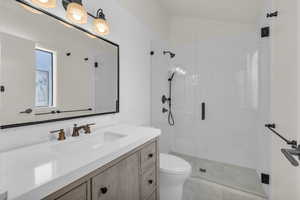 Full bath featuring vanity and a stall shower