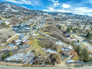 Snowy aerial view with a mountain view and a residential view