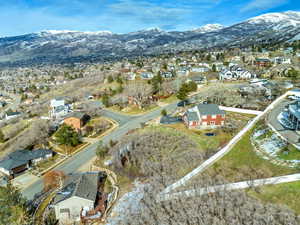 Aerial view of property's location with nearby suburban area and a mountainous background