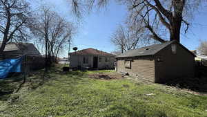 Back of house with an outbuilding