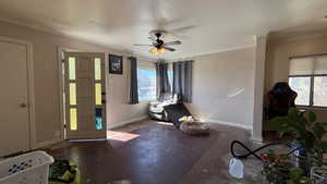 Entrance foyer with ceiling fan and crown molding