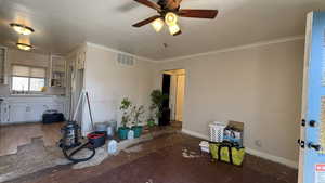 Kitchen with a ceiling fan, white cabinets, crown molding, light countertops, and open shelves