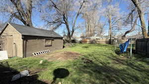 Fenced backyard with an outdoor structure