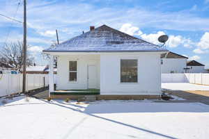 View of front of house featuring a chimney and covered porch