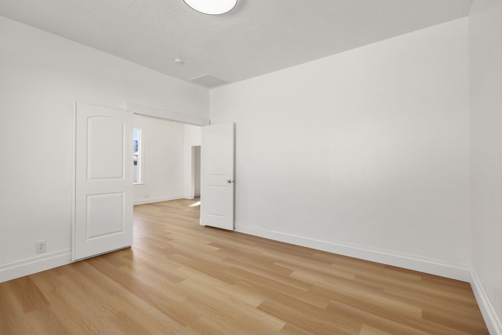 Spare room with baseboards and light wood finished floors
