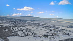 Snowy aerial view featuring a mountain view