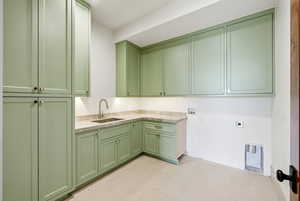 Laundry room featuring cabinet space, hookup for a washing machine, and electric dryer hookup