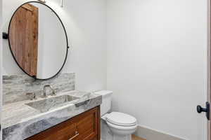 Half bath with vanity and toilet