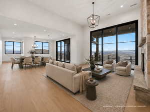 Living room featuring suspended lighting and light wood-style floors