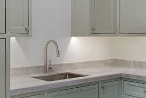 Kitchen view of light stone countertops and a sink