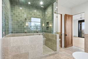 Bathroom with a shower stall, recessed lighting, tile patterned floors, tile walls, and a ceiling fan