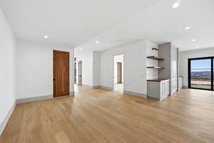 Unfurnished living room with light wood-style flooring and recessed lighting