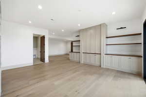 Unfurnished living room with light wood finished floors and recessed lighting