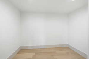 Empty room featuring light wood-style flooring and baseboards