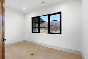 Spare room featuring light wood-style floors and recessed lighting