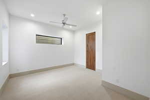 Empty room featuring light carpet, a ceiling fan, and recessed lighting