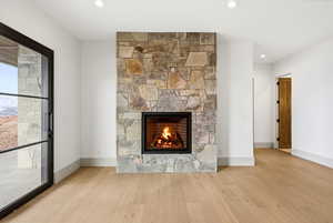 Detailed view of wood finished floors and a fireplace