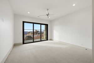 Carpeted empty room featuring a ceiling fan and recessed lighting