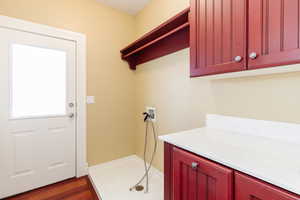 Laundry area featuring washer hookup and dark wood-style floors