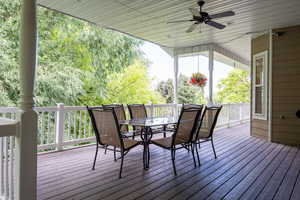 Wooden terrace featuring a ceiling fan and outdoor dining area