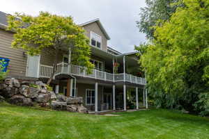 Rear view of house featuring a yard and a patio