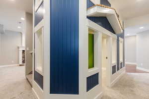 Hall featuring recessed lighting and light colored carpet