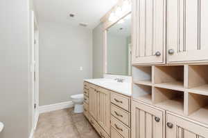 Full bath featuring vanity and light tile patterned floors