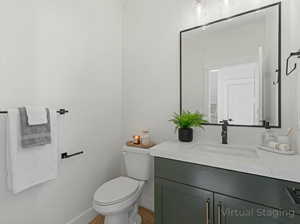 Half bath featuring vanity and toilet