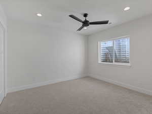 Unfurnished room featuring light carpet, recessed lighting, and a ceiling fan