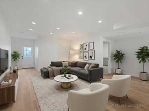 Living area with recessed lighting and light wood-type flooring